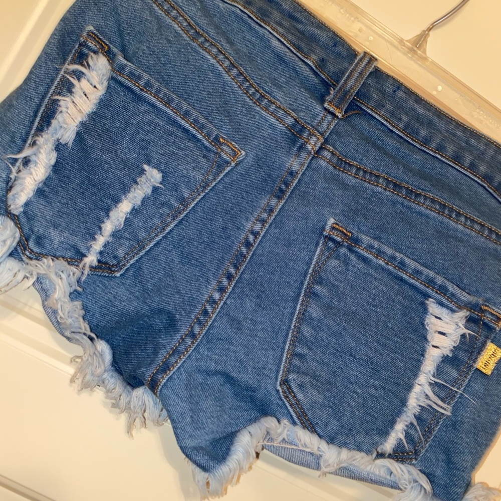 Ripped blue jean shorts